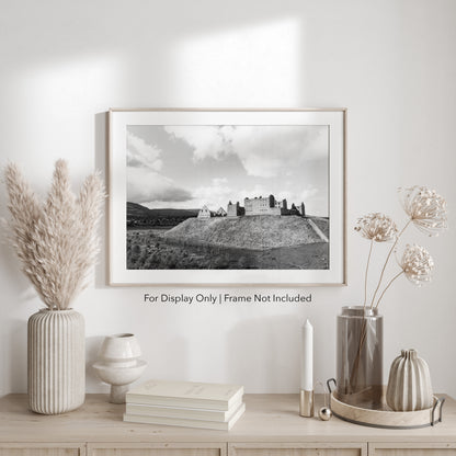 Black-and-white photograph of Ruthven Barracks ruins in the Scottish Highlands, set on a grassy hill with dramatic skies.