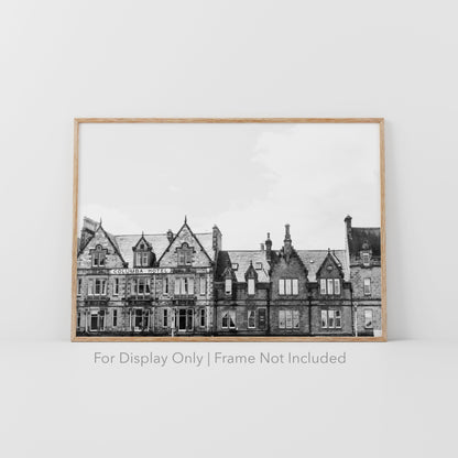 Black and white photograph of the historic Columba Hotel building in Inverness, Scotland, with stone architecture and gabled rooftops.