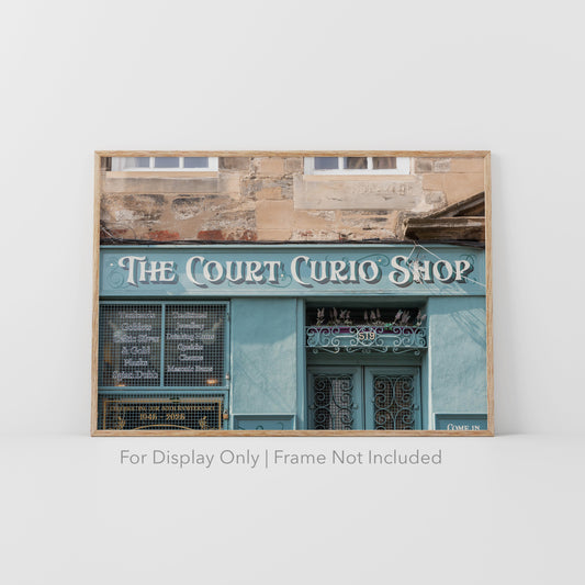 The Court Curio Shop in Edinburgh, Scotland, with teal storefront, ornate lettering, and historic stone facade.