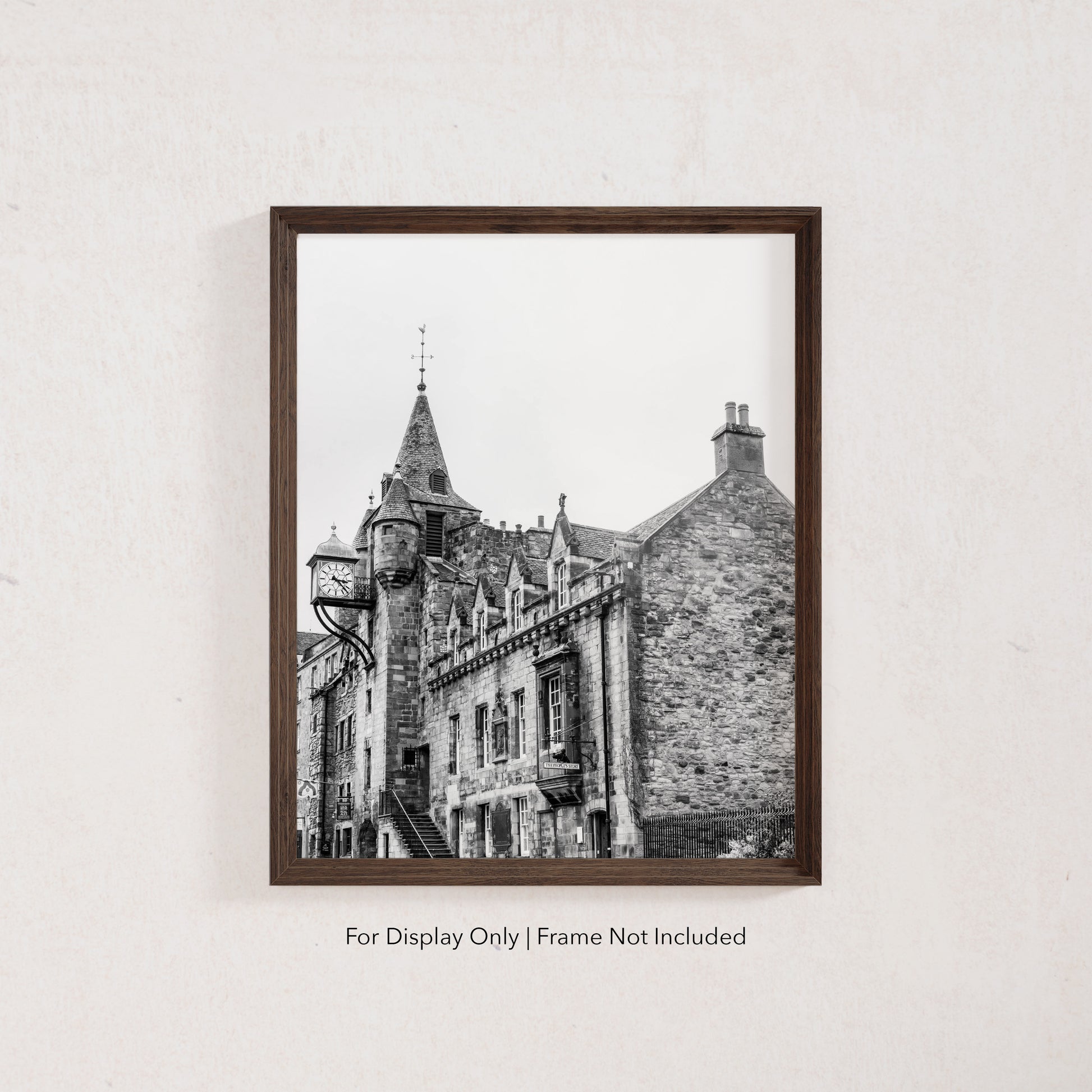 Black and white photograph of the Canongate Tolbooth clock tower on Edinburgh’s Royal Mile, historic stone building with Gothic details.