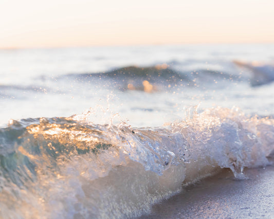 Golden sunlight shines through a breaking ocean wave on the Gulf Coast in Destin, Florida, coastal wall art.