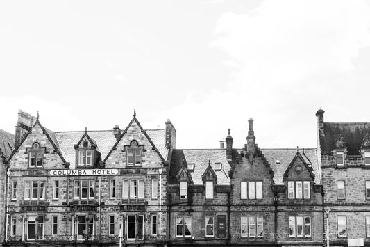 Black and white photograph of the historic Columba Hotel building in Inverness, Scotland, with stone architecture and gabled rooftops.