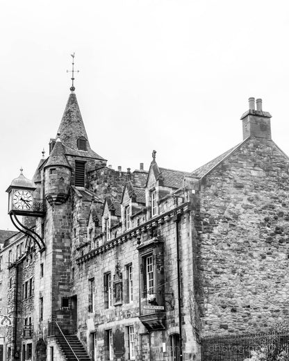Black and white photograph of the Canongate Tolbooth clock tower on Edinburgh’s Royal Mile, historic stone building with Gothic details.
