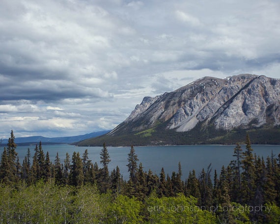 a view of a mountain range with a lake in the foreground