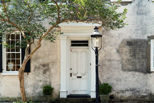 a white door with a lamp post in front of it