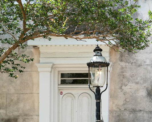 a lamp post in front of a white door