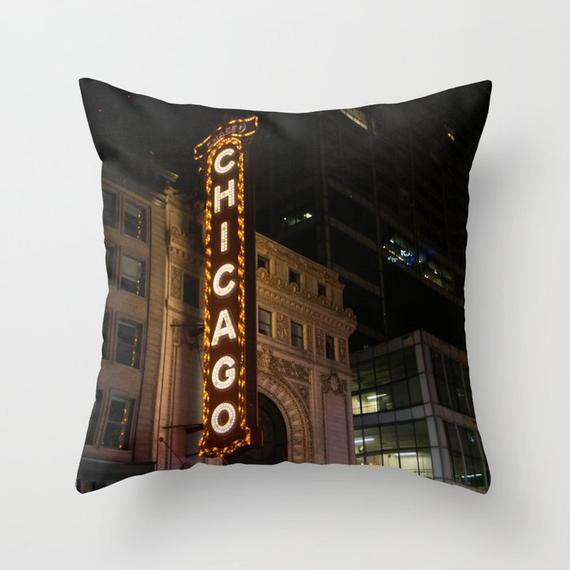 a pillow with the chicago sign lit up at night