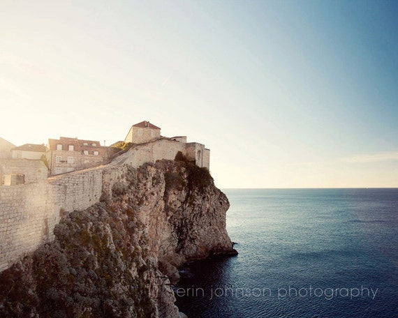 a castle on a cliff overlooking the ocean