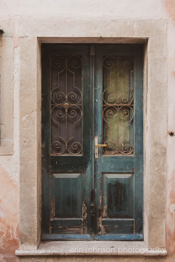 a blue door with iron bars on it