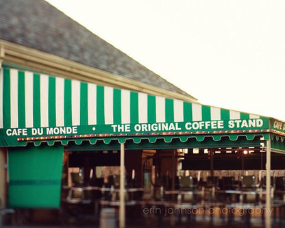 A photograph of a green and white striped awning over a coffee shop in New Orleans
