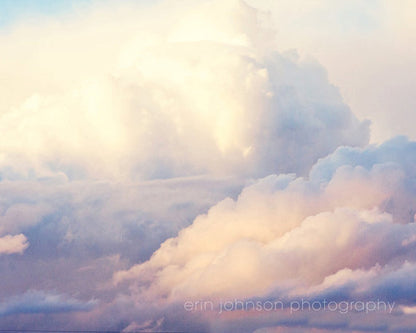 A landscape photograph featuring a cloudy sky with pink and blue hues.