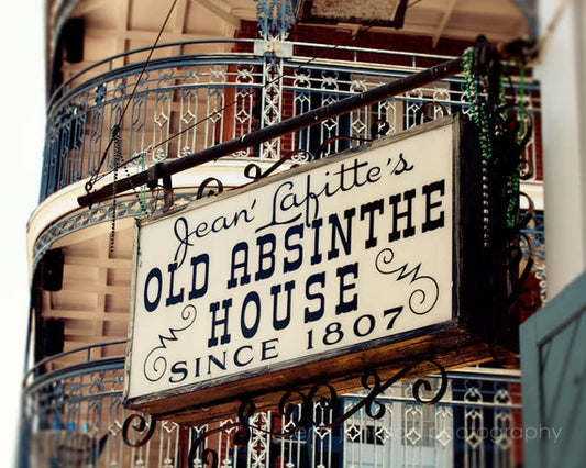 a sign hanging from the side of a building