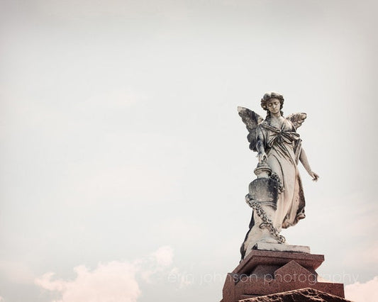 a statue of an angel on top of a building