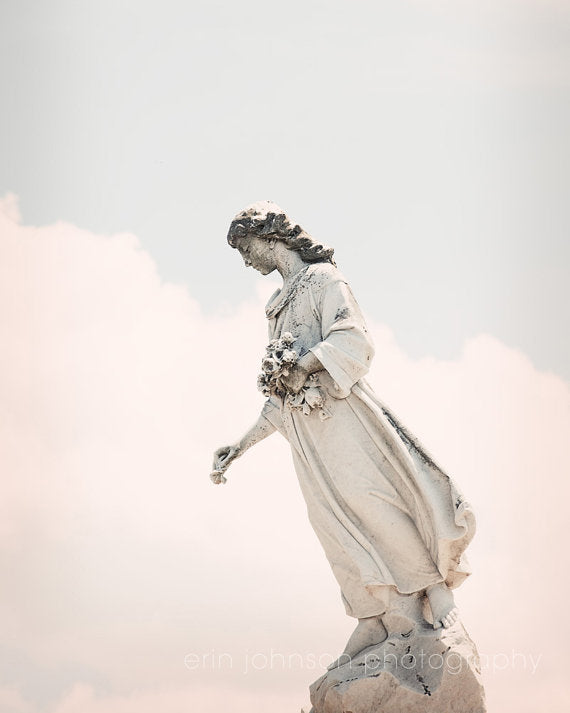 a statue of a woman holding a bouquet of flowers