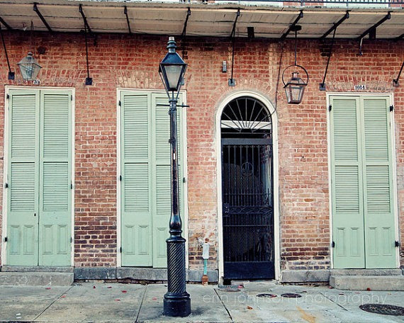 a street light sitting in front of a brick building