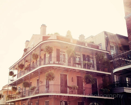 a building with balconies and plants on the balconies