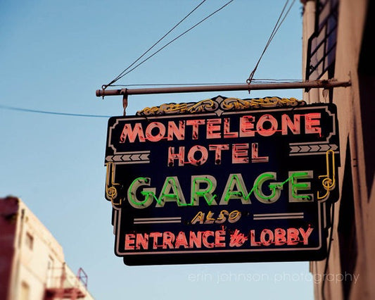 a neon sign hanging from the side of a building