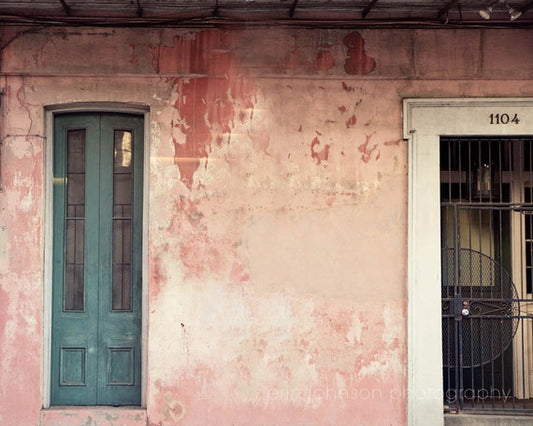 an old building with a blue door and a window