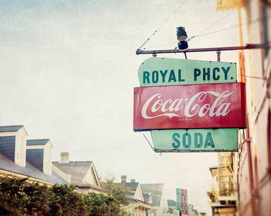 a neon sign hanging from the side of a building