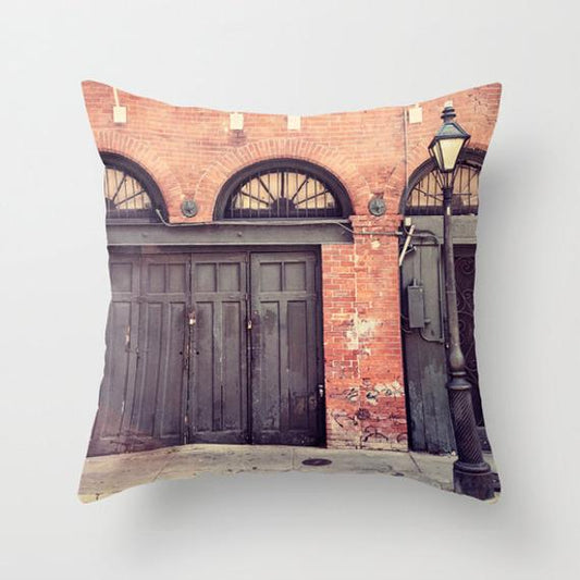 a throw pillow with a picture of two doors