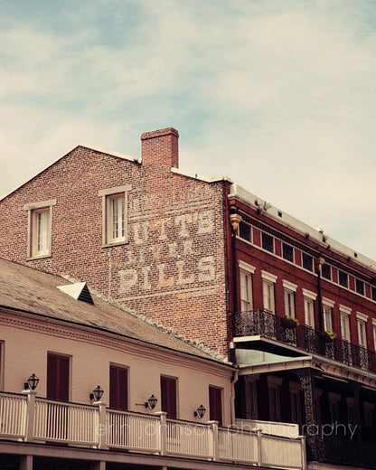 Photography print of Butt's Liver Pills vintage advertisement on the side of a building in New Orleans, Louisiana French Quarter.