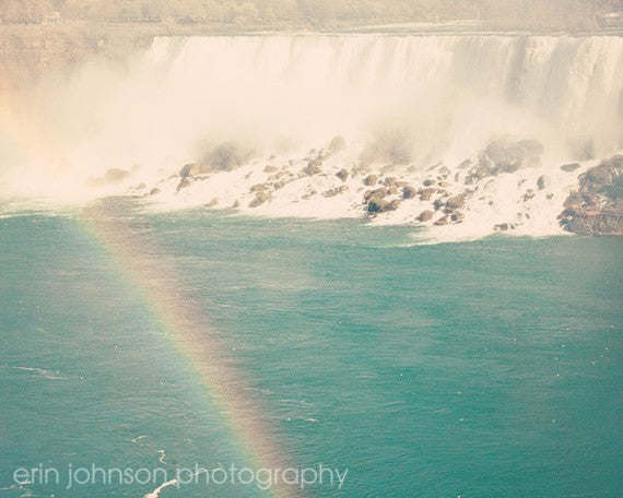 a rainbow in the middle of a waterfall