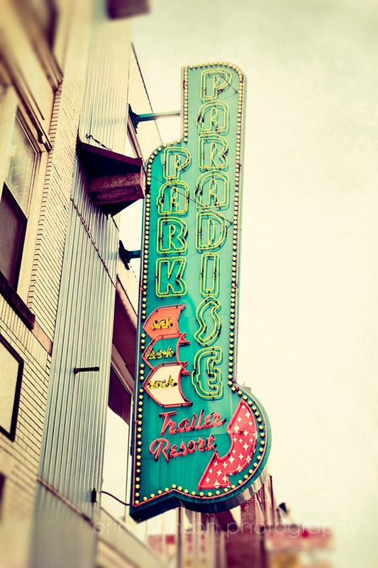 a large neon sign on the side of a building