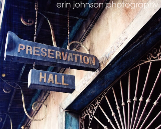 a street sign hanging from the side of a building