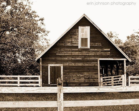 a black and white photo of a barn