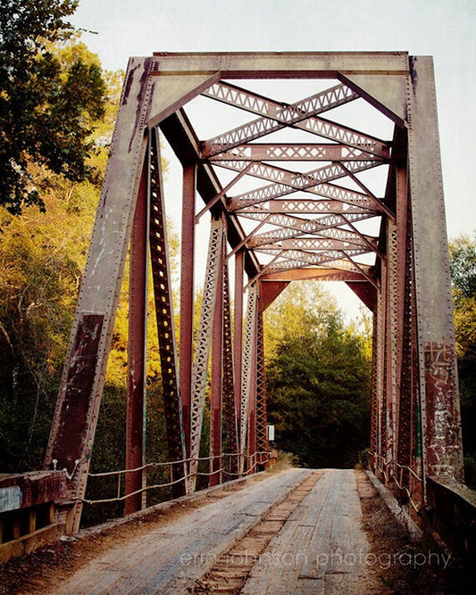 an old rusty bridge is shown in this image