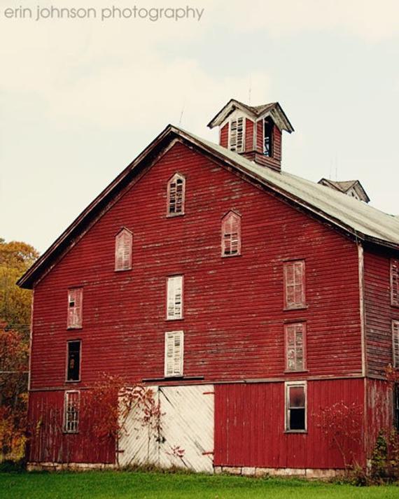 an old red barn with a steeple on top
