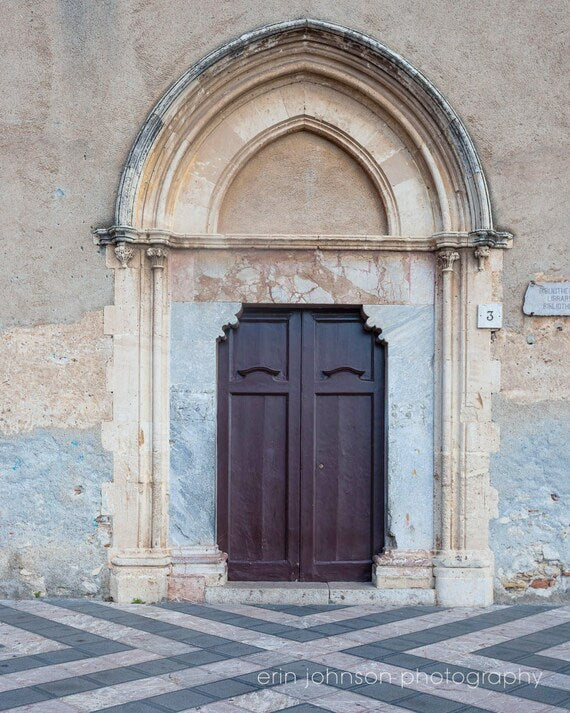 a large wooden door in front of a stone building