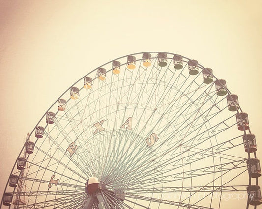 a large ferris wheel sitting next to a tall building