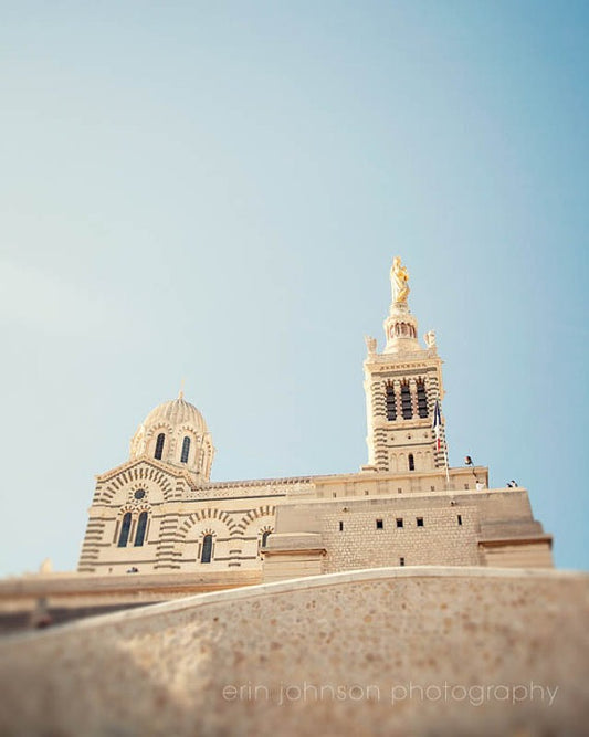 a tall building with a golden statue on top of it