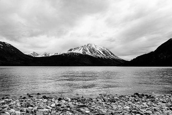 a black and white photo of a mountain lake