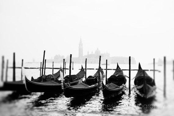 a row of gondolas sitting on top of a body of water