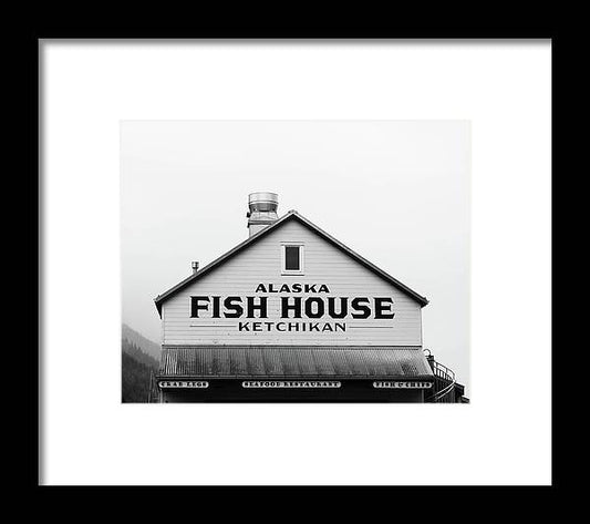 a black and white photo of a fish house