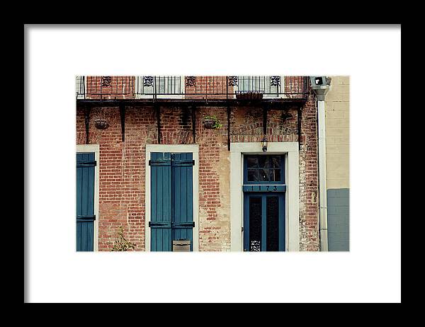 a brick building with blue doors and windows