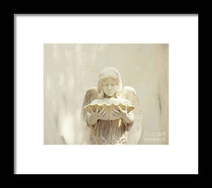 a statue of an angel holding a tray