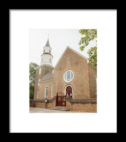 a church with a steeple and a gate in front of it