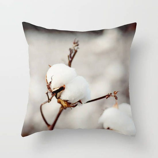 a pillow with a cotton plant on it