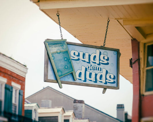 a sign hanging from the side of a building