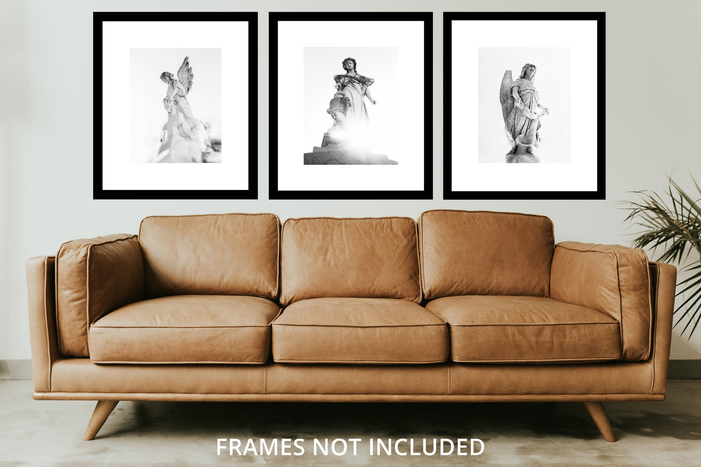a living room with a couch and three pictures on the wall