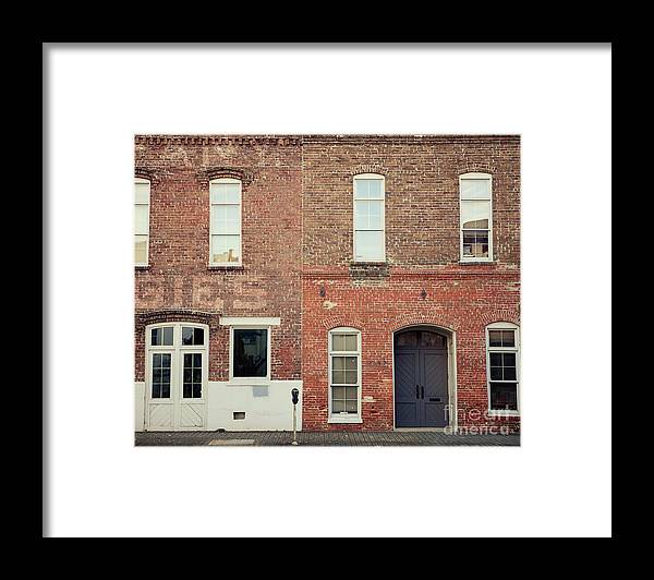 a brick building with three windows and a door