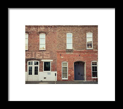 a brick building with three windows and a door