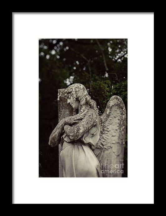 a black and white photo of an angel statue