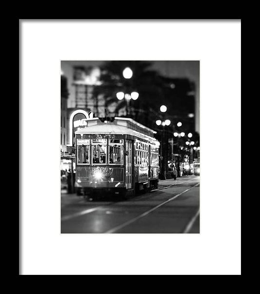 a black and white photo of a trolley on a street