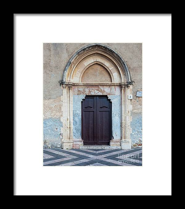 an old building with a wooden door and a striped floor